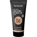 A black tube of Benecos Natural Creamy Makeup 30ml, labeled vegan, with a new moisturising foundation formula. Beige color is visible at the bottom and product text appears in white and beige on the front.