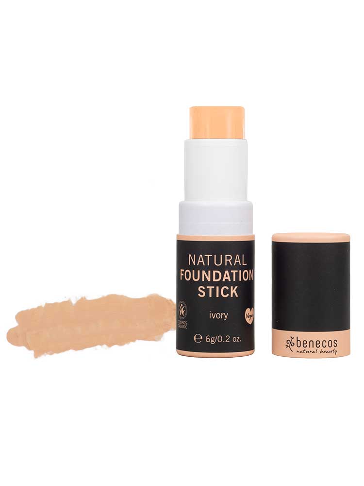 A Benecos Natural Foundation Stick 6g in ivory is shown with the cap removed, revealing the vegan formula. To the left, a swatch displays the natural finish shade.