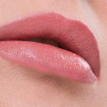 Close-up of lips wearing Benecos Natural Lipsticks 4.5g in a smooth, peach shade, set against a soft, peach-toned background. The word "Peach" appears below the lips.