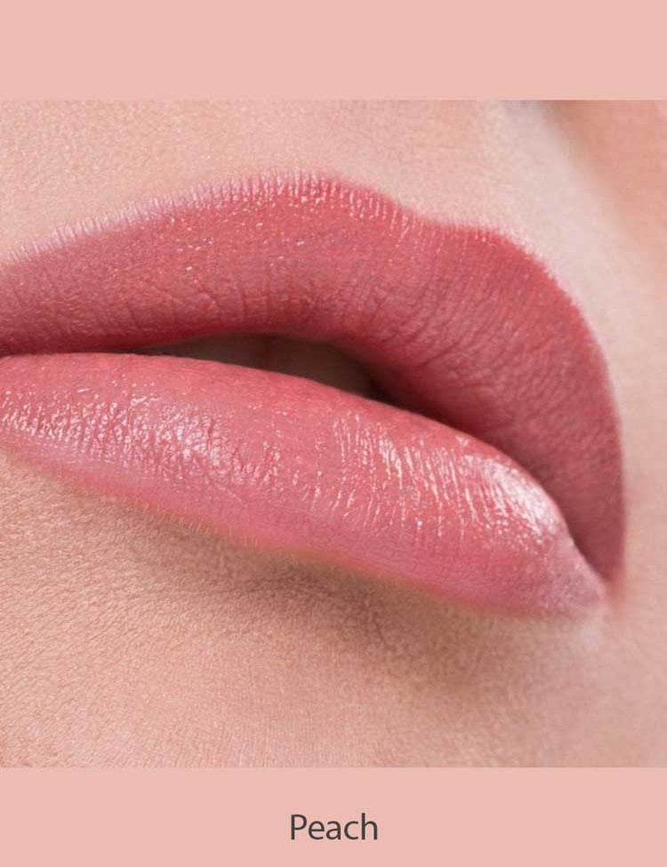 Close-up of lips wearing Benecos Natural Lipsticks 4.5g in a smooth, peach shade, set against a soft, peach-toned background. The word "Peach" appears below the lips.