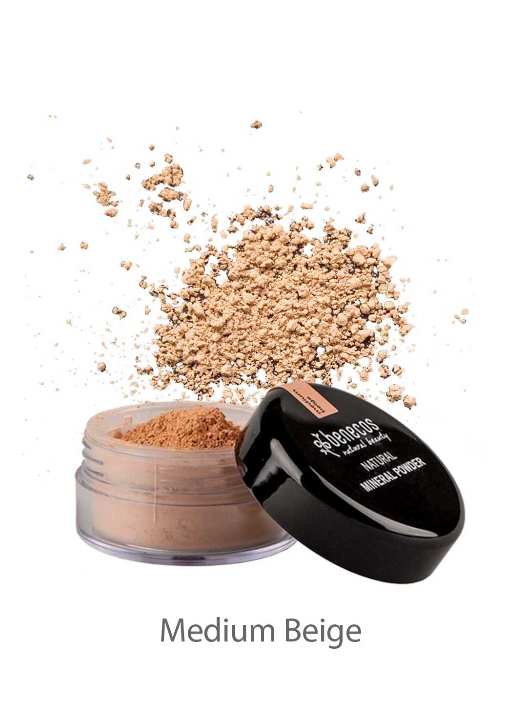 An open jar of Benecos Natural Mineral Powder 10g in medium beige, with talc-free loose powder scattered above the container. The black lid reads "sheeress mineral powder for a smooth, matte finish.