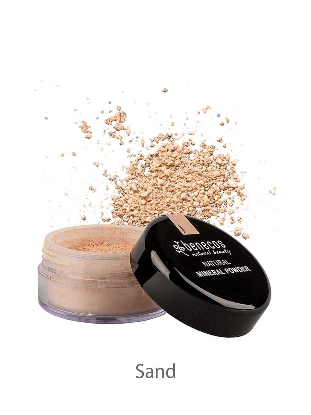 An open container of Benecos Natural Mineral Powder 10g in the shade Sand with a matte finish, loose powder scattered around it, and the black lid set aside.