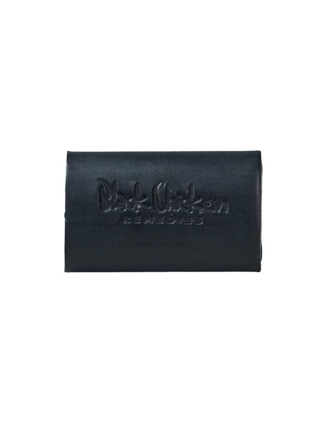The Black Chicken Remedies D-Bar Activated Charcoal Detox Soap 100g is a rectangular black bar embossed with the logo, ideal for armpit detox or switching to natural deodorant. Photographed on a plain white background.