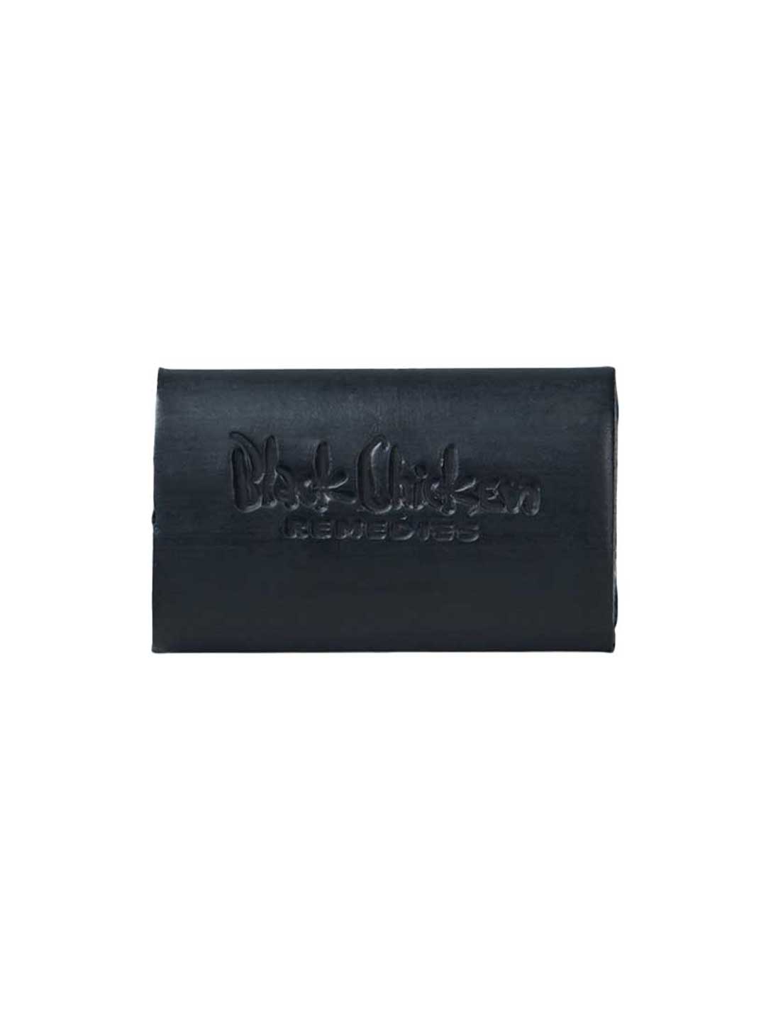 The Black Chicken Remedies D-Bar Activated Charcoal Detox Soap 100g is a rectangular black bar embossed with the logo, ideal for armpit detox or switching to natural deodorant. Photographed on a plain white background.