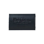 The Black Chicken Remedies D-Bar Activated Charcoal Detox Soap 100g is a rectangular black bar embossed with the logo, ideal for armpit detox or switching to natural deodorant. Photographed on a plain white background.