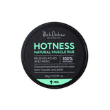 A 28g round black container labeled Black Chicken Remedies Hotness Natural Muscle Rub features arnica in a 100% natural warming balm to help relieve aches and pains, with directions to peel the label for more information.