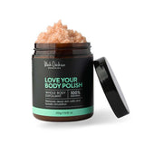 A jar of Black Chicken Remedies Love Your Body Polish Natural Body Scrub 250g with the lid open reveals a pink, granular scrub made with Himalayan Pink Salt for gentle exfoliation; the label states it is 100% natural.