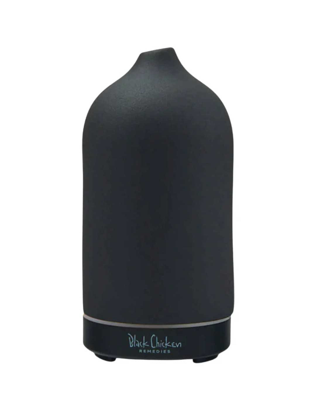 The Black Chicken Remedies Skypipe Essential Oil Diffuser features a sleek, matte black ceramic design with a smooth, rounded top and branding at the base.