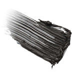 A thick, textured swipe of 100% Pure Fruit Pigmented® Ultra Lengthening Mascara 10g, applied in one stroke on a white background, with visible brush lines and soft, fading edges to the left.