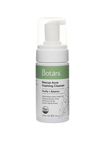 A 100ml bottle of Botani Rescue Acne Foaming Cleanser features a pump dispenser and a green-white label highlighting salicylic acid. Vegan and cruelty-free icons emphasize this natural face wash.