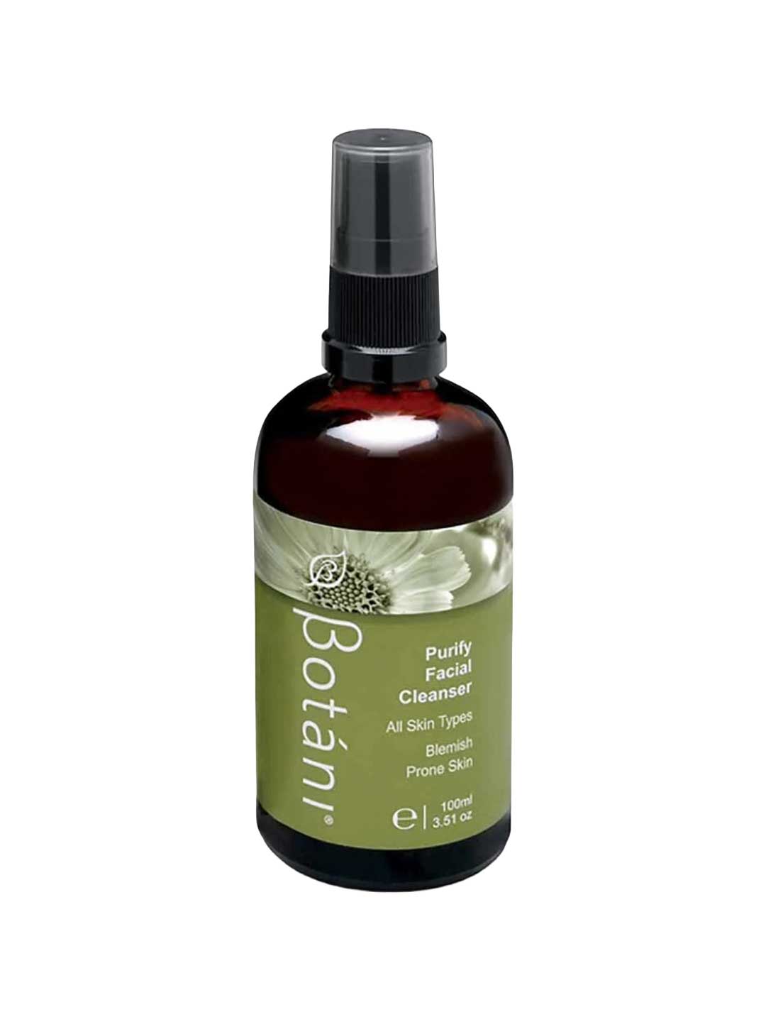 A 100ml amber glass bottle of Botânii Purify Facial Cleanser with a black spray cap and an olive green label, shown on a plain white background.