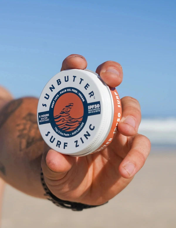 SunButter Vegan Surf Zinc SPF50 held at the beach