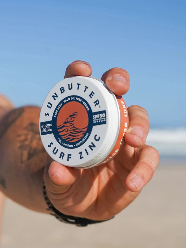 SunButter Vegan Surf Zinc SPF50 held at the beach