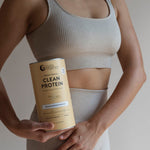Woman holding Nutra Naturals Clean Plant Protein Creamy Vanilla