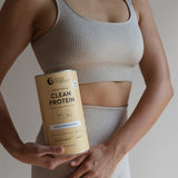 Woman holding Nutra Naturals Clean Plant Protein Creamy Vanilla