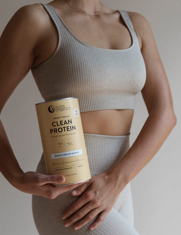 Woman holding Nutra Naturals Clean Plant Protein Creamy Vanilla