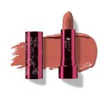 The 100% Pure Fruit Pigmented® Pomegranate Oil Moisturising Lipstick 4.5g, a vegan lipstick with a metallic pink cap and floral design, is shown next to a swatch of its Calendula (coral pink nude) shade enriched with pomegranate oil.