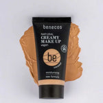 A 30ml tube of Benecos Natural Creamy Makeup stands upright on a matching smear, with product details and vegan makeup label clearly visible.