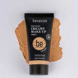 A 30ml tube of Benecos Natural Creamy Makeup stands upright on a matching smear, with product details and vegan makeup label clearly visible.