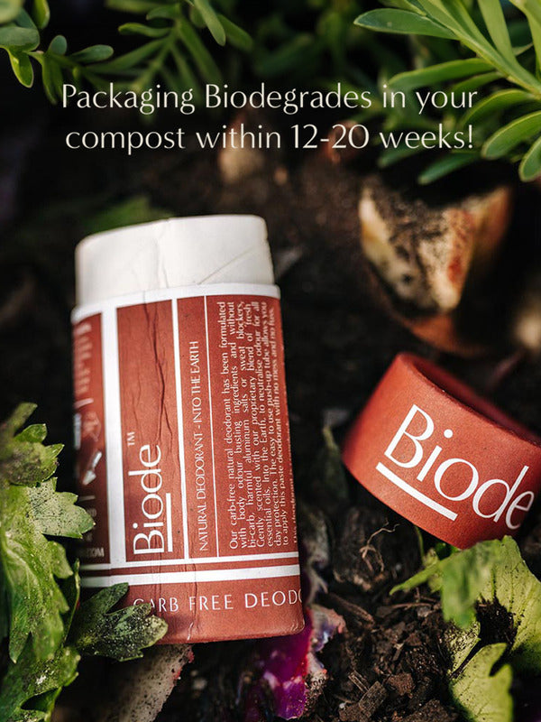 Terracotta Biode Into the Earth deodorant tube and detached cap among leaves and compost. Text states that the packaging biodegrades in compost within 12–20 weeks.