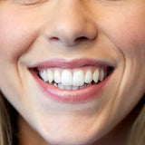 A close-up shows a smiling person's straight, white teeth and lips tinted with Luk Beautifood Lip Nourish Lipsticks 3g in Chai Shimmer. The words "Chai Shimmer" appear at the bottom of the image.