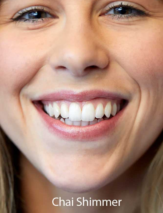 A close-up shows a smiling person's straight, white teeth and lips tinted with Luk Beautifood Lip Nourish Lipsticks 3g in Chai Shimmer. The words "Chai Shimmer" appear at the bottom of the image.