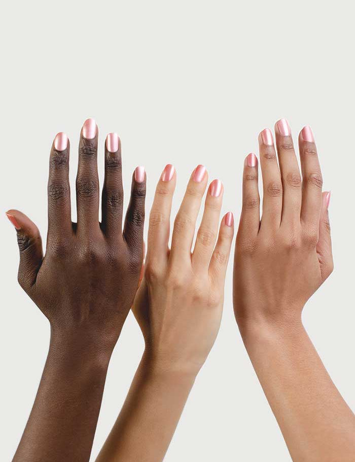 Three hands of different skin tones with neatly manicured nails, all painted in Sienna Byron Bay Nail Polish - Charm 10ml (a warm pink satin shade), displayed against a plain light background.