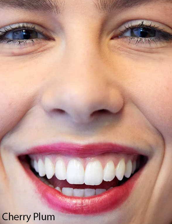Close-up of a smiling person’s face with white teeth, pink lipstick, and blue eyes. “Cherry Plum” appears in the corner, highlighting Luk Beautifood Lip Nourish Lipsticks 3g for nourishing buildable coverage.