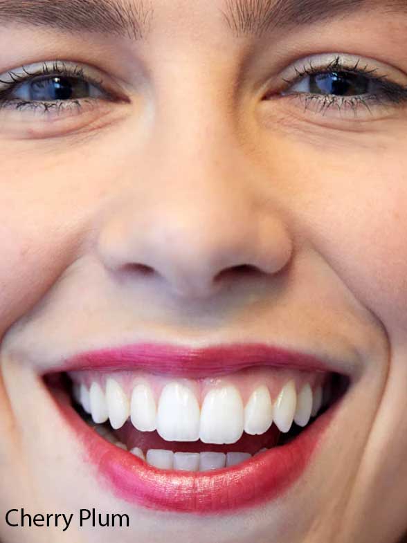 Close-up of a smiling person’s face with white teeth, pink lipstick, and blue eyes. “Cherry Plum” appears in the corner, highlighting Luk Beautifood Lip Nourish Lipsticks 3g for nourishing buildable coverage.