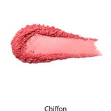 A smear of 100% Pure Rice Powder Pressed Blush 9g in the shade Chiffon is displayed on a white background, offering a natural flush and buildable coverage.