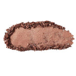 A swatch of 100% Pure Fruit Pigmented® Eye Shadow 2g by 100% Pure, in shimmery bronze, is roughly smeared in an oval with crumbly edges on a white background.