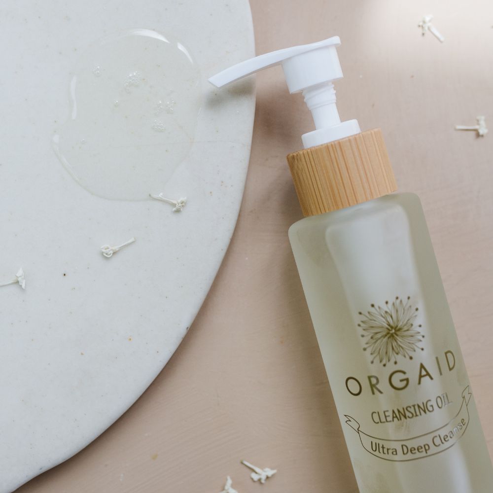 Orgaid Cleansing Oil styled on a bathroom vanity
