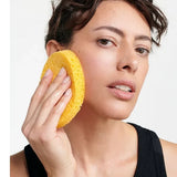 Model using the Dr Hauschka Oval Cleansing Sponge