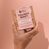 Hand holding Nutra Naturals Collagen Beauty Watermelon Strawberry 225g