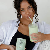 Woman with an iced Nutra Naturals Collagen Matcha Latte
