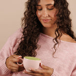 Woman enjoying Nutra Naturals Collagen Strawberry Matcha Latte