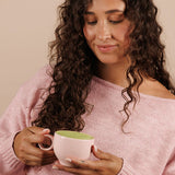 Woman enjoying Nutra Naturals Collagen Strawberry Matcha Latte