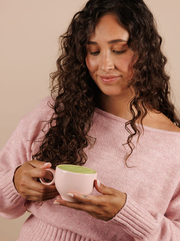 Woman enjoying Nutra Naturals Collagen Strawberry Matcha Latte
