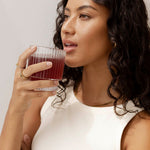 Woman enjoying Nutra Naturals Collagen Beauty Watermelon Strawberry