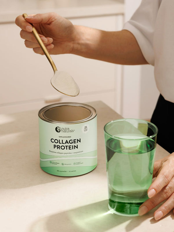 Spooning Nutra Naturals Collagen Protein into a glass