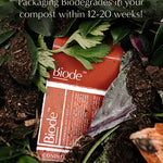 Terracotta Biode Into the Earth conditioner packaging among leaves and compost. Overlaid text states that the packaging biodegrades in compost within 12–20 weeks.