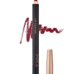 A crimson INIKA Organic Lip Crayons 6.7g with a color swatch behind it, labeled LIP CRAYON and INIKA ORGANIC. A gold cap sits beside it, while "Crimson" below highlights this long-lasting organic lip liner.