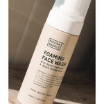 Noosa Basics Foaming Face Wash for acne-prone skin on a sunlit stone surface.
