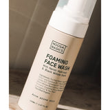 Noosa Basics Foaming Face Wash for acne-prone skin on a sunlit stone surface.