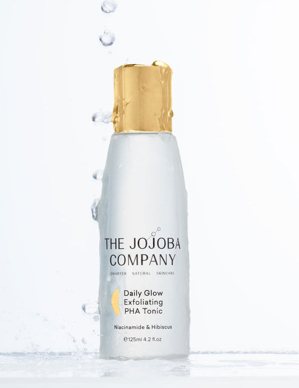 The Jojoba Company Daily Glow Exfoliating PHA Tonic with water splashes