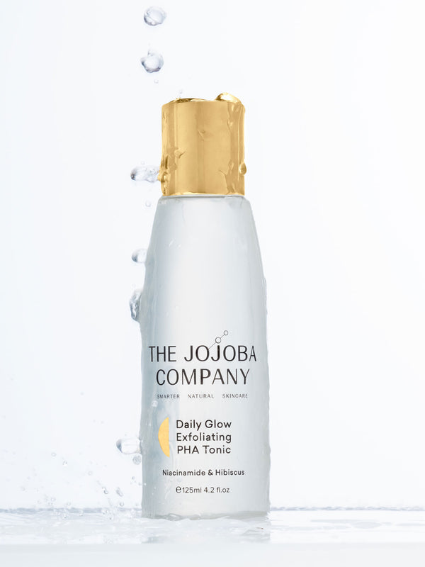 The Jojoba Company Daily Glow Exfoliating PHA Tonic with water splashes