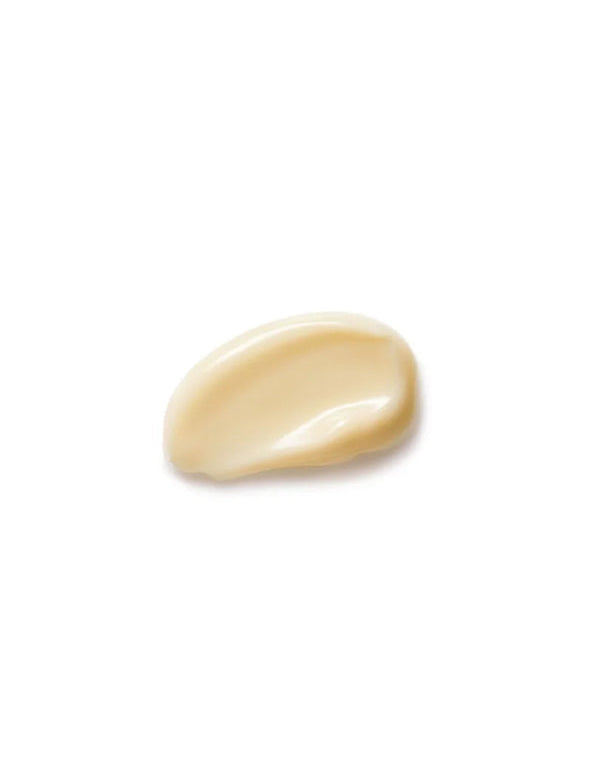 Close-up of a smooth pale ivory Dr Hauschka Daily Hydrating Eye Cream dollop with a glossy curved ridge on white.
