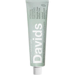 Green toothpaste tube with 'Davids' branding on a white background