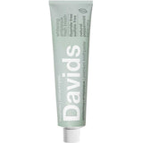Green toothpaste tube with 'Davids' branding on a white background