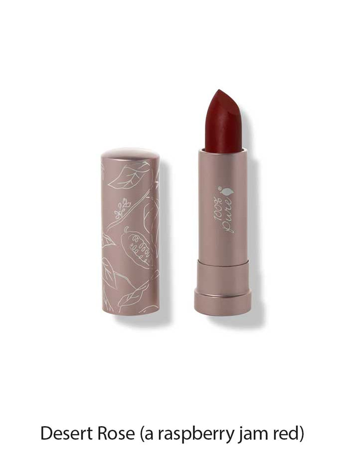The 100% Pure Cocoa Butter Matte Lipsticks 4.5g is shown in a rosy mauve tube with white floral designs and the cap off, revealing a deep red shade. Text below reads: Desert Rose (a raspberry jam red).